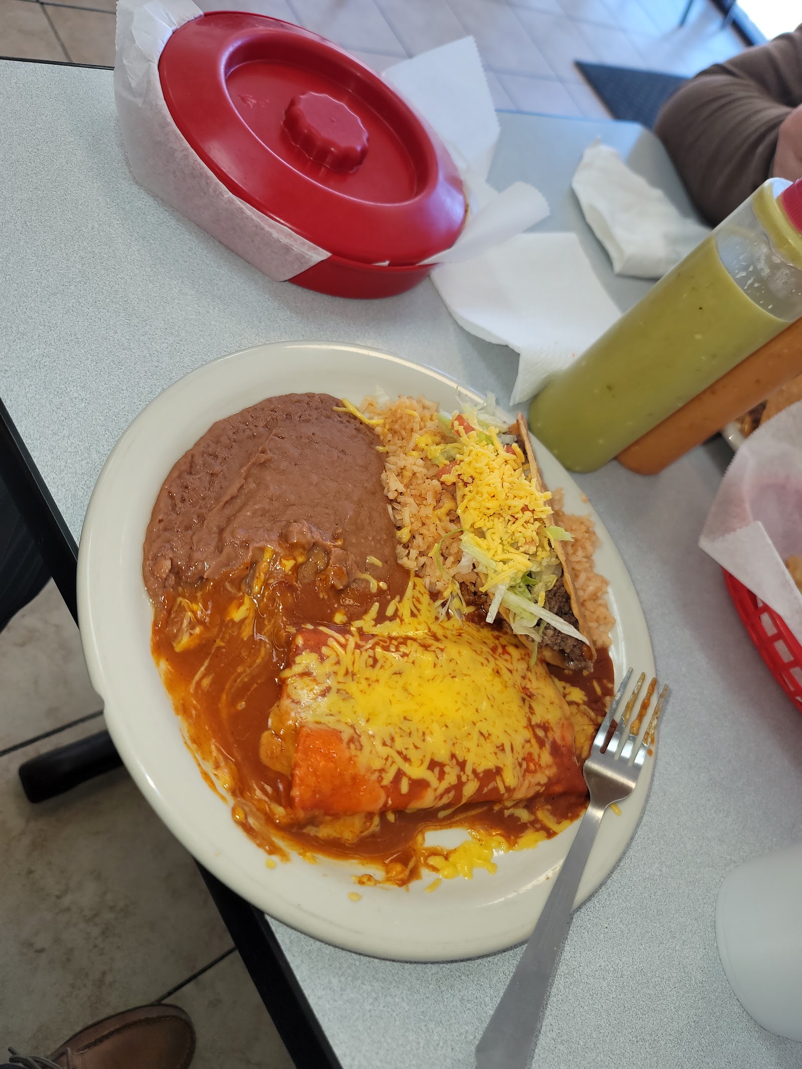 Bean and cheese enchilada plate with taco, rice, and beans