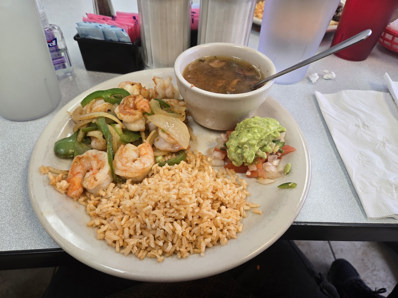 Shrimp plate with rice, soup, and guacamole